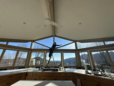 Gutter and window cleaning crew working on a mountain home near blue ridge parkway